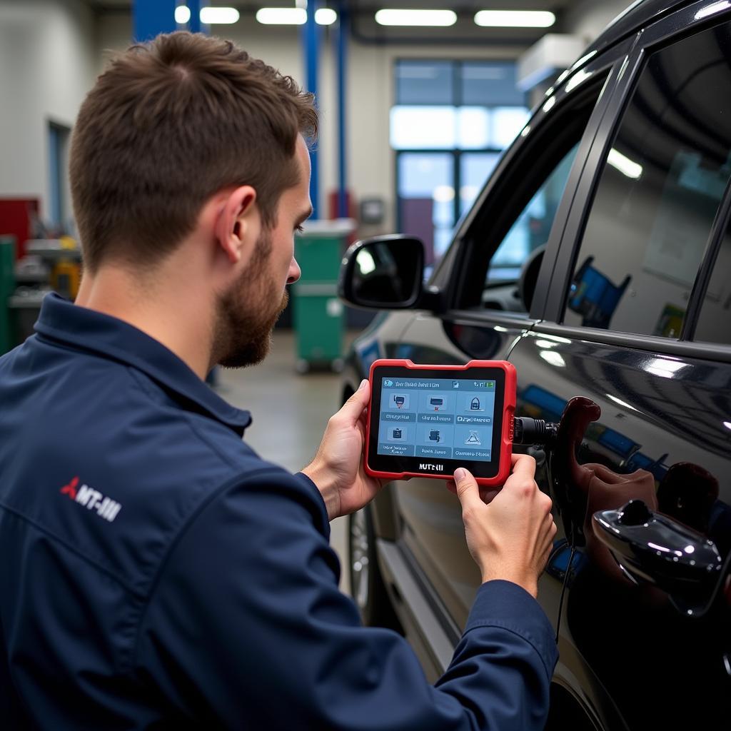 Mechanic using MUT-III scan tool in workshop